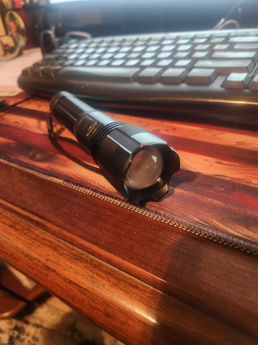 Close-up of the lens and crenellated metal bezel on Rob's flashlight
